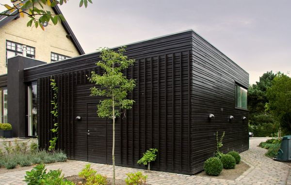 Husfacade af sortmalet træ.