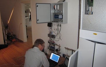 De sidste afsluttende tests gennemføres, inden husets automatik er klar til at sende målinger omkring husets indeklima direkte til projektets hjemmeside. Foto: Henrik Blyt