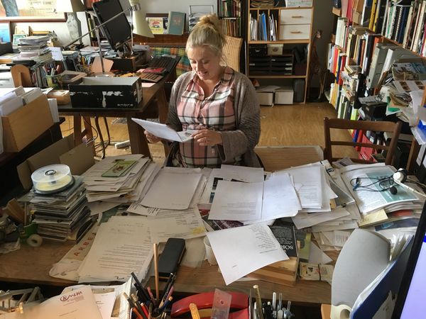 Gravid kvinde rydder op på skrivebord