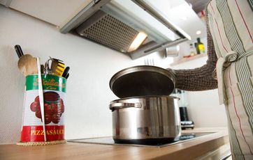 Låget løftes af en gryde på et komfur